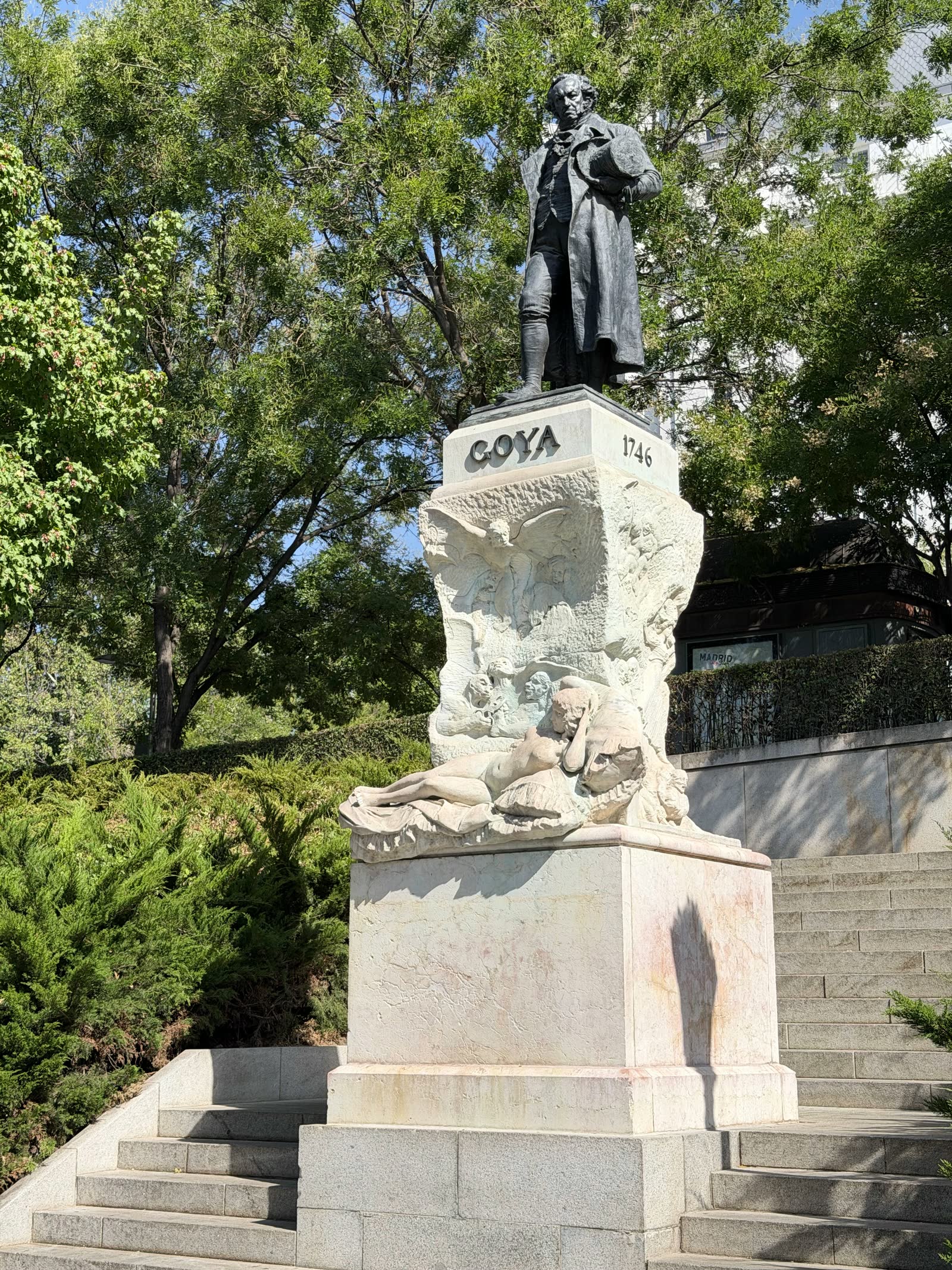 Monument to Francisco Goya framed by trees outside the Prado Museum in Madrid